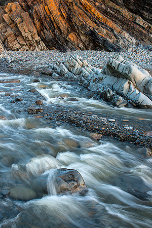 The river cascades towards the sea, Welcombe Mouth, Devon.